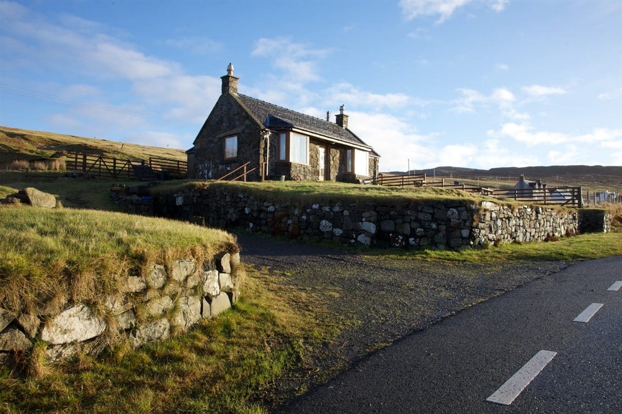 Auld Mission Cottage from the road around Waternish with views of Lochbay