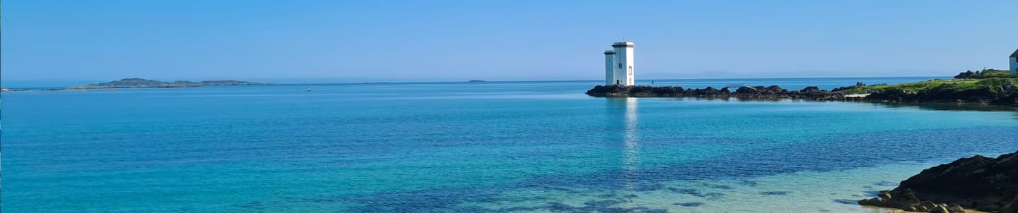 lighthouse by bay on isle of islay