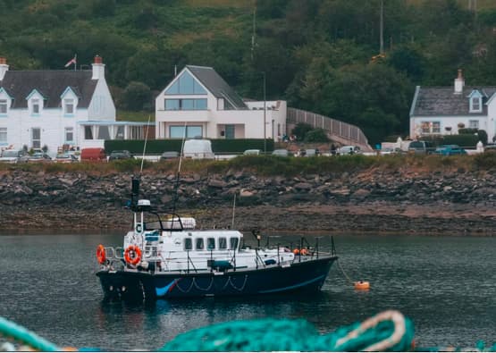 boat entering port in mallaig