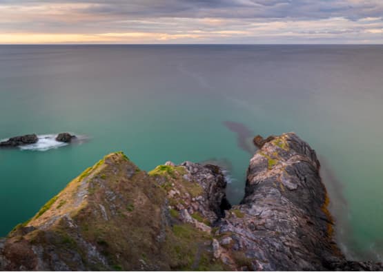 cliff face overlooking rocks and ocean
