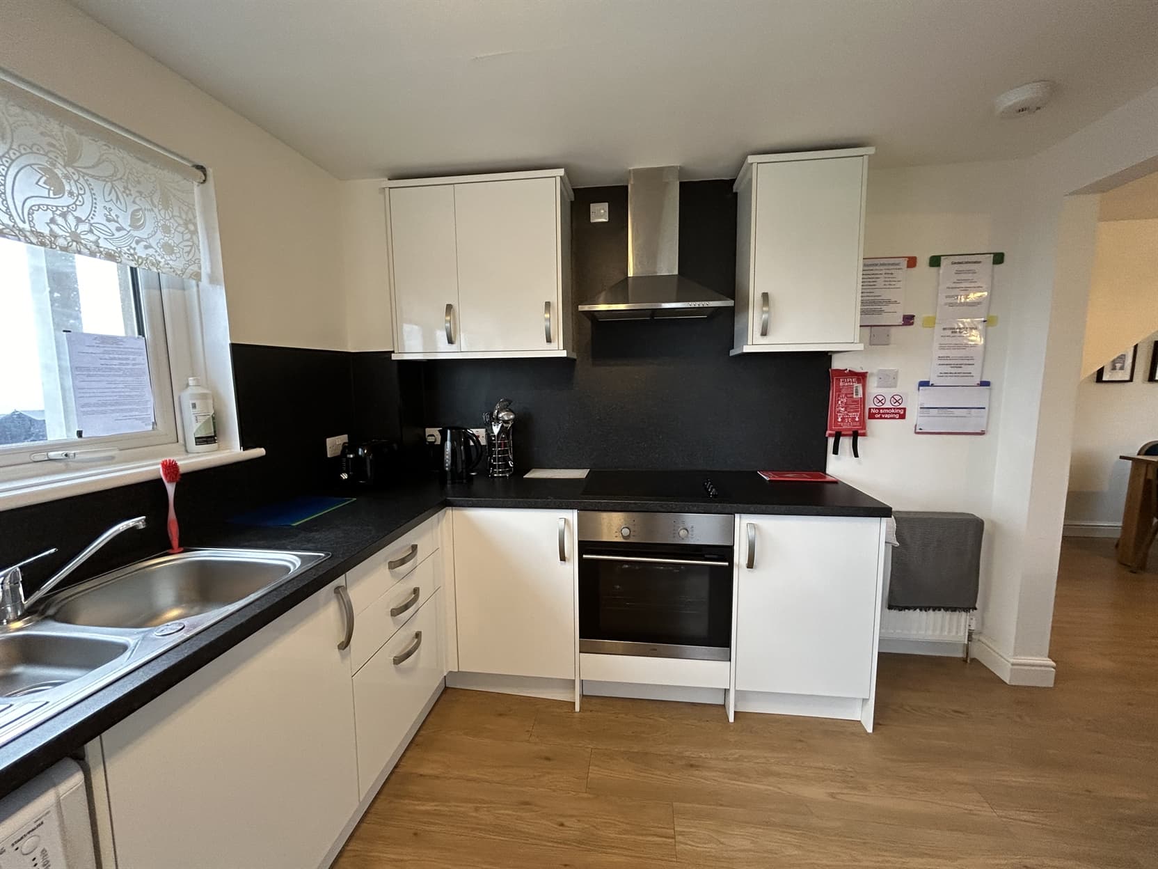 Fully equipped kitchen with oven, hob, microwave, kettle, and dining area — designed for home-style cooking.