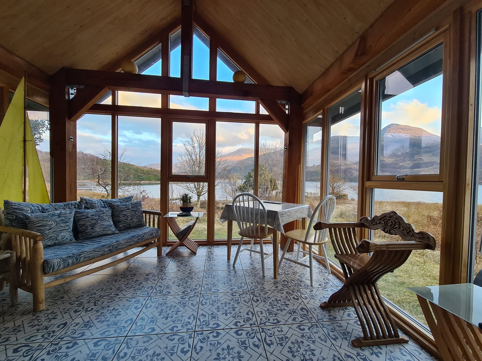 Glass extension with panoramic views to Loch Ailort and the hills beyond.