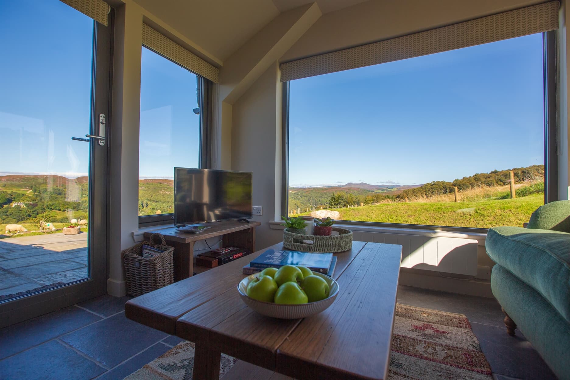 Panoramic view of surrounding hills looking through picture windows in the living area
