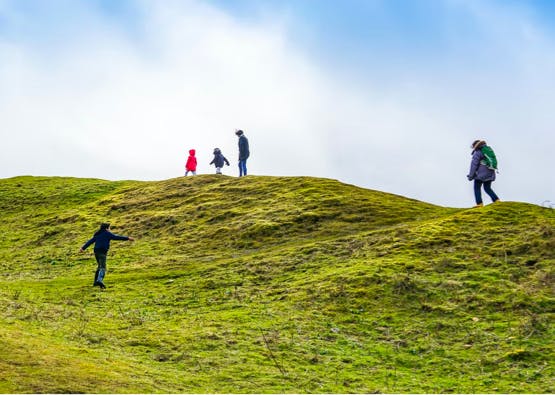 family exploring hill in scotland