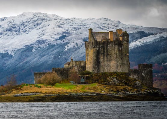 castle in scotland with loch in foreground