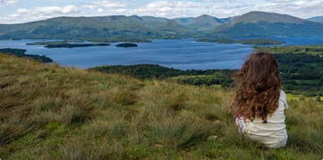 family holiday in scotland with girl looking at loch
