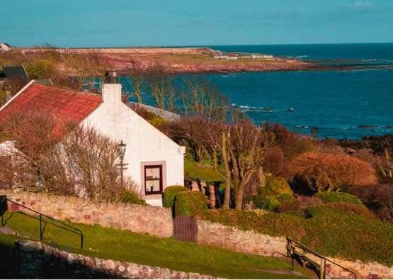 white cottage overlooking the ocean in fife