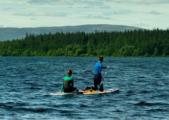 couple paddleboarding on loch ness
