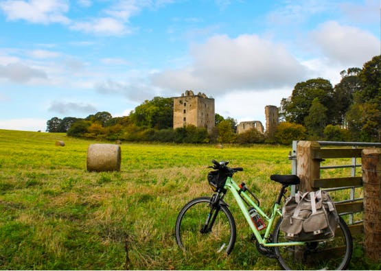 bicycle with field and castle in background