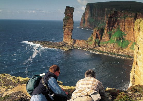 people enjoying view of cliffside in orkney